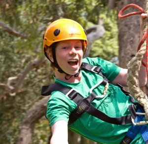 Happy Boy in yellow helmet on Flying Fox