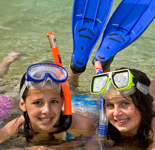 Two girls in snorkels and Goggles in the pool